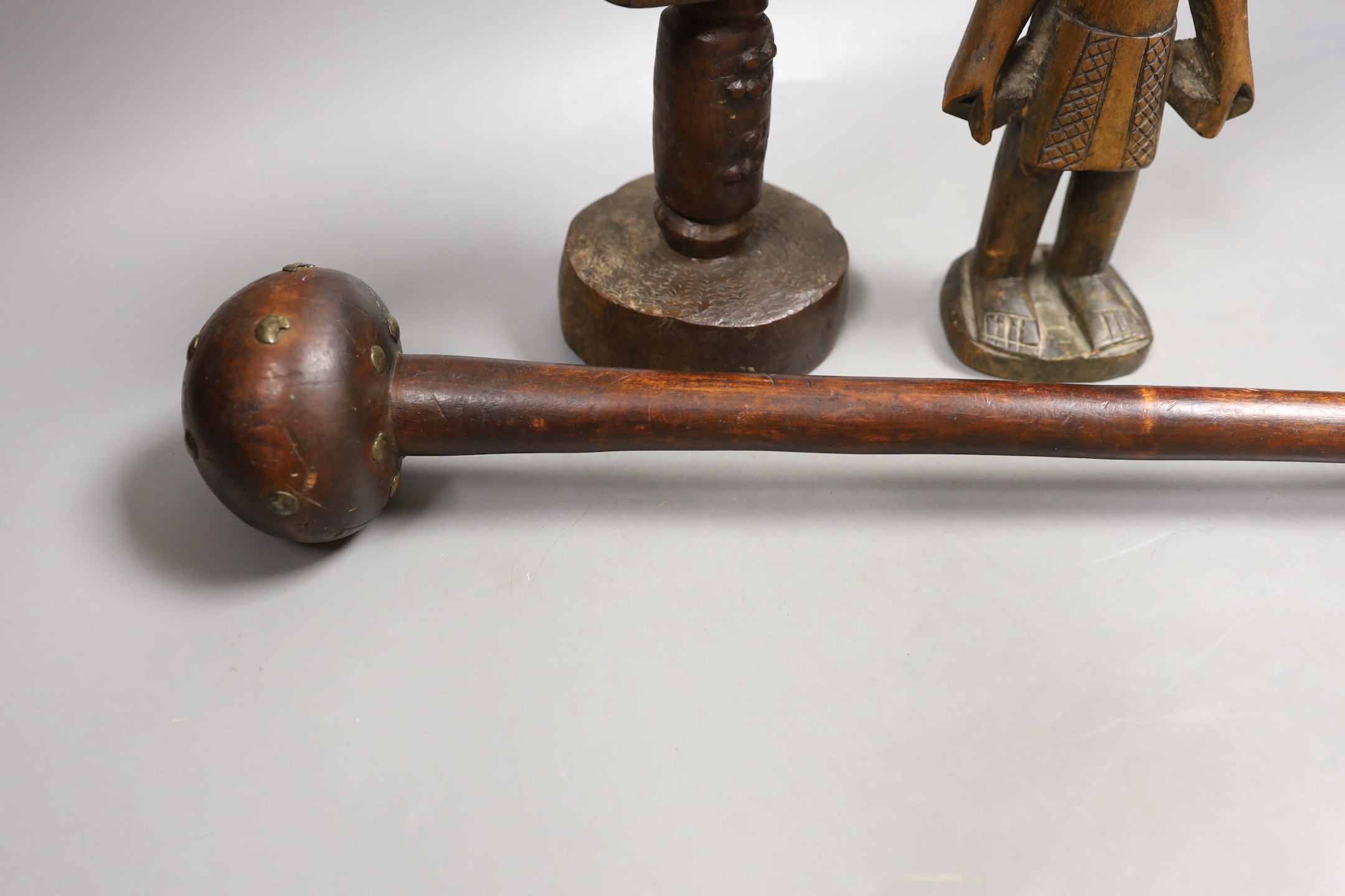 A Zulu knobkerrie, an Ibeji wood figure and a Gabon Fanti fertility figure- Knobkerrie 73 cms long.